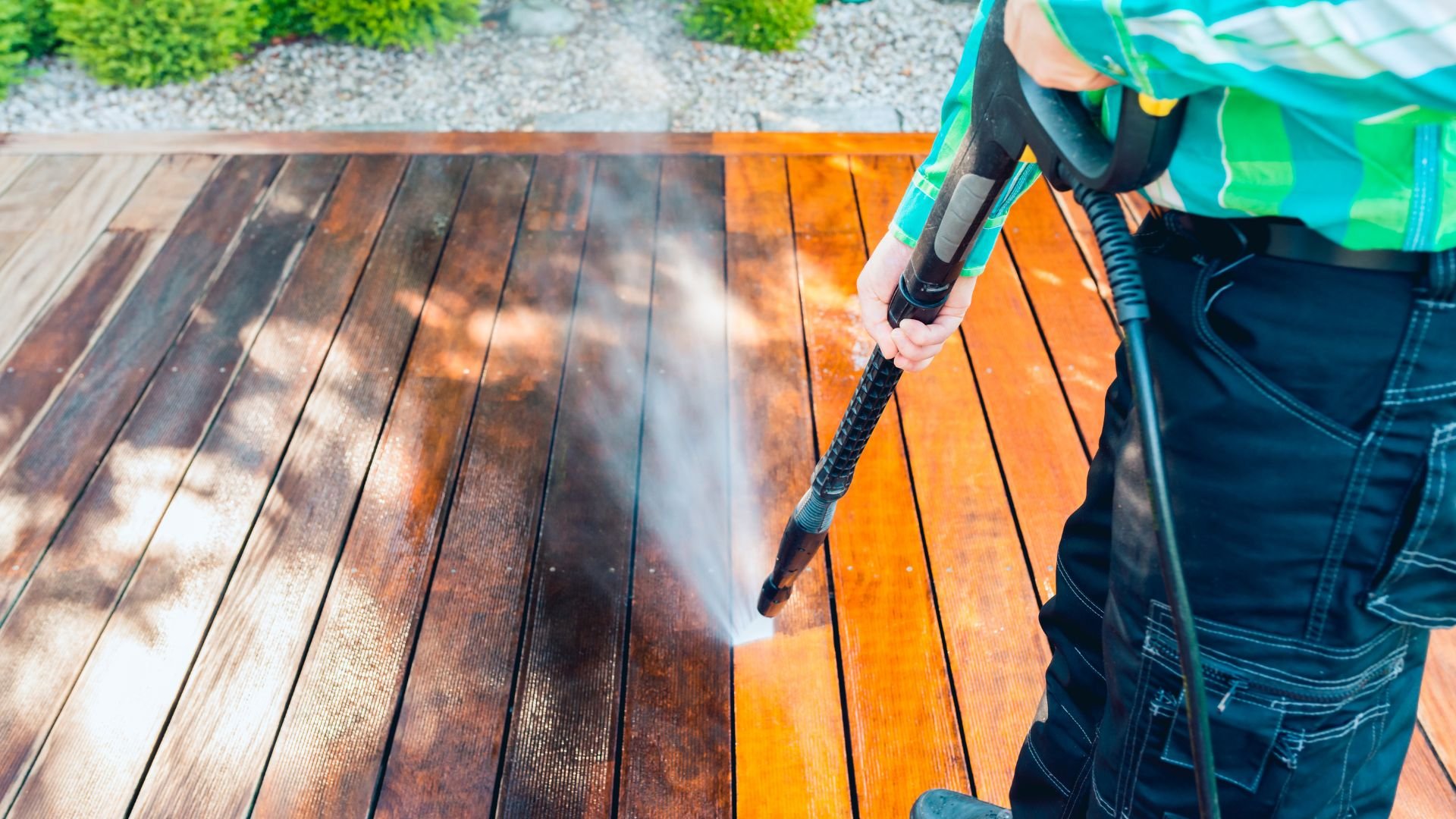 Cleaning wooden deck with high-pressure power washer